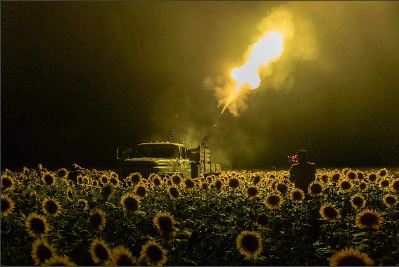 Ukrainian servicemen of the 59th brigade mobile air defence unit fire a Soviet-made ZU-23 anti-aircraft twin auto-cannon towards a Russian drone from a sunflower field